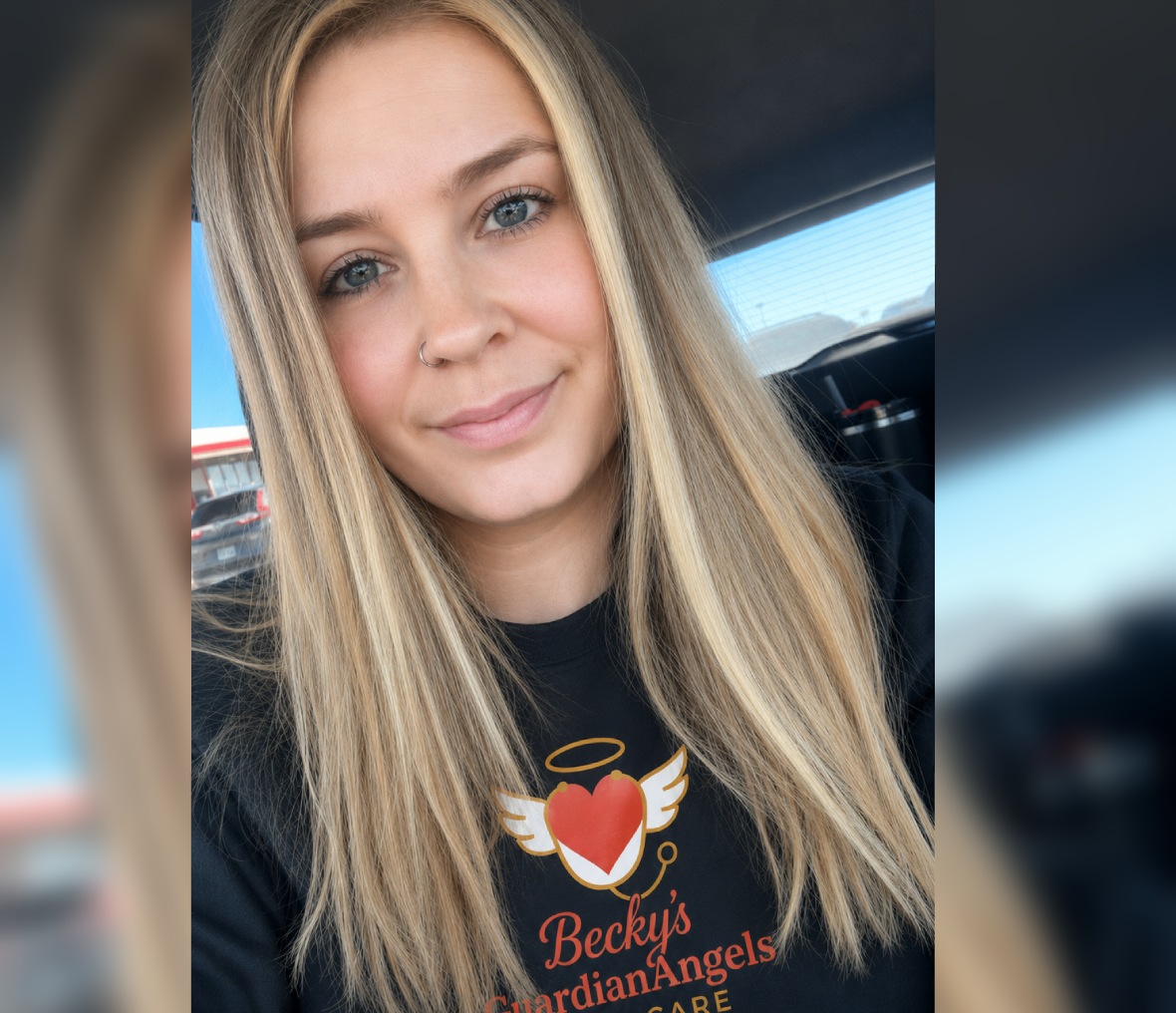 Smiling blonde woman taking selfie inside car